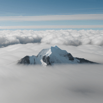 Breathtaking Snowy Mountain Peaks Above the Clouds