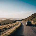 An adventurous car journey down a picturesque hill, full of excitement.
