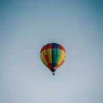 A stunning aerial shot of a hot air balloon in the sky, showcasing the vibrant colors and majestic flight.