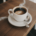 An aromatic scene of a steaming coffee cup on a rustic wooden table.