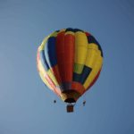 A majestic hot air balloon ride above the horizon, providing breathtaking views and an exhilarating experience.