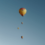 A majestic hot air balloon floating among the clouds, offering a serene and picturesque aerial view.