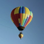 A vibrant hot air balloon gracefully floating in the sky, capturing the essence of adventure and exploration.