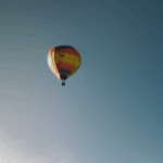 A close-up view of a colorful hot air balloon gliding through the sky, embodying the spirit of exploration.