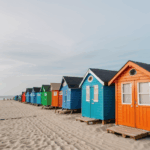 Charming beach huts painted in bright colors along the beachfront