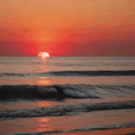 Tranquil sea under a mesmerizing sunset sky.