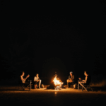 A laid-back campfire night scene with friends unwinding.