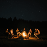 A group of friends enjoying a campfire under the night sky.
