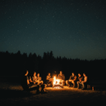 Stories and laughter shared around an evening campfire.