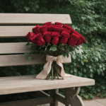 A captivating rose bouquet elegantly displayed on a rustic wooden bench.