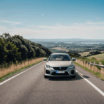 Car driving scenery with a vehicle navigating a picturesque hill.