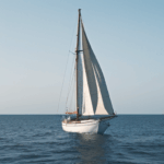 Charming sailboat journey across a calm sea, a perfect blend of elegance and serene ocean exploration.