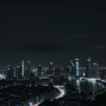 The beauty of urban night captured in a cityscape with lit skyscrapers against a backdrop of the dark sky.