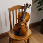 An alluring violin on a rustic wooden chair, perfect for music enthusiasts.