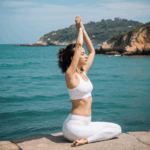 Peaceful coastal yoga practice, capturing the harmony of a yogi's pose against the backdrop of gentle ocean waves.