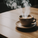 Perfect coffee moments captured with a steaming cup on a wooden surface, exuding warmth.