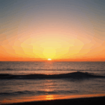 Colorful ocean sunset with the sky ablaze in vibrant, warm colors.