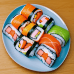 A vibrant display of colorful sushi rolls artfully arranged on a plate, showcasing the beauty of Japanese cuisine.