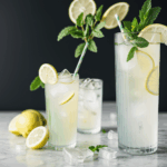A cool mint-infused lemonade, served with ice cubes and fresh mint for a refreshing taste.