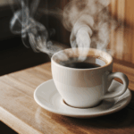 A cozy moment captured with a steaming cup of coffee on a wooden table.