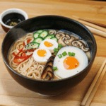 Close-up of delicious toppings on a steaming bowl of ramen, highlighting the rich flavors.