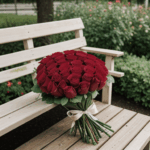 An elegant arrangement of roses on a wooden bench, exuding romance and charm.