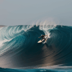 A breathtaking image of a surfer conquering an epic wave, highlighting the power of the ocean.