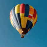 A vibrant hot air balloon drifting through the sky, inviting dreamers to embark on a skyward journey.
