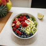 A vibrant bowl of fresh fruit showcasing a mix of colors on a kitchen counter.