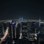 Futuristic architecture illuminated at night, showcasing the innovative designs and bright city lights of a modern metropolis.