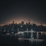 A futuristic urban landscape at night, characterized by modern skyscrapers and a vibrant tapestry of city lights.