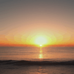 Golden sunset over the ocean, with vibrant colors reflecting on the water.