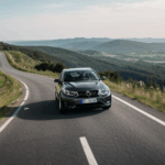 Hill driving excitement captured as a car navigates a steep descent.