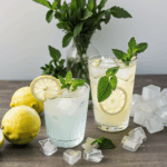 Iced lemon drink with mint garnish, offering a perfect blend of citrus and coolness for summer.