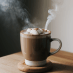 Indulgent winter brew in a mug of hot cocoa, with a swirl of cream and a sprinkle of chocolate shavings.