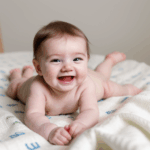 A playful infant exploring the texture of a cozy blanket.