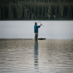 Angling by the lakeside in a serene setting, capturing nature's peace.