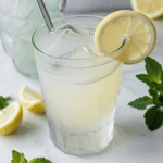 Icy lemonade with mint leaves, served in a clear glass.