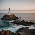 A majestic lighthouse standing on a rocky coast, illuminated by a vibrant sunset.