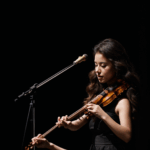 A live violin concert with a skilled violinist enchanting the audience with beautiful, expressive music.
