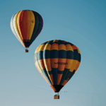 A colorful hot air balloon ascending above the horizon, creating a picturesque and captivating scene.