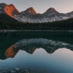 A majestic mountain peak bathed in the gentle light of sunrise, overlooking a serene lake, evoking a sense of wonder and tranquility in nature.