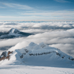 The majestic summit towering above a sea of clouds, offering an awe-inspiring sight of alpine splendor and tranquility.