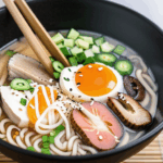 A delightful noodle soup experience with a steaming bowl of ramen, topped with flavorful ingredients.