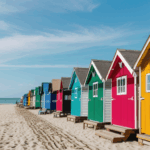 Vibrant beach huts nestled along the coast, with ocean views