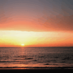 Ocean horizon lit by a breathtaking sunset, with tranquil scenery all around.