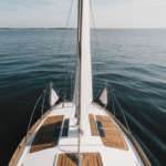 Ocean serenity captured by a classic sailboat sailing gracefully across the calm sea, epitomizing nautical elegance.