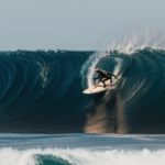 A skilled surfer riding an ocean wave, demonstrating their expertise and passion for surfing.