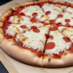 Oven baked pizza steaming hot with a variety of savory toppings and a golden crust