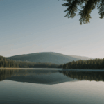 A serene lake with crystal-clear reflections of the surrounding trees and sky, embodying nature's tranquility.